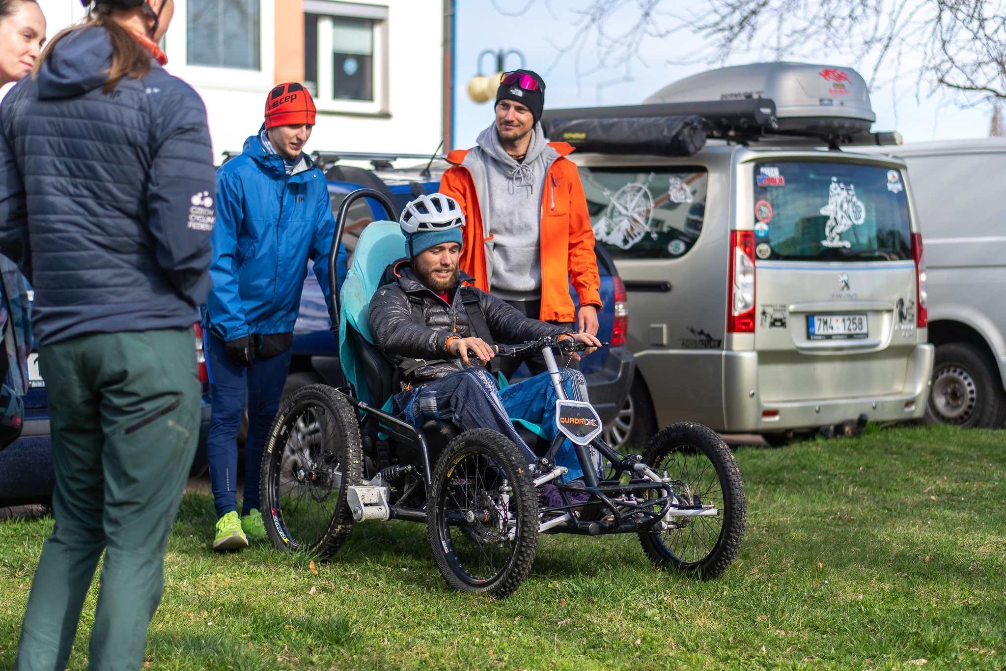 3 persons going for a hike, one with special wheelchair for nature trails.